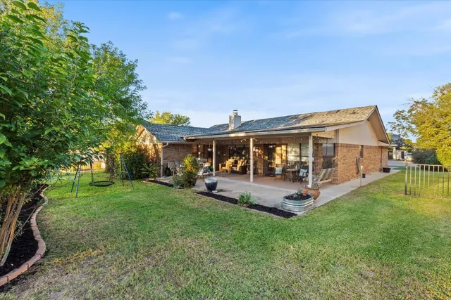 a front view of house with a garden and patio