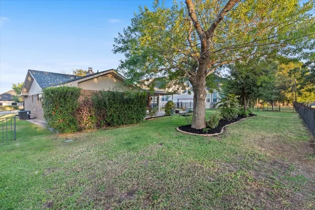 a view of a garden with large trees