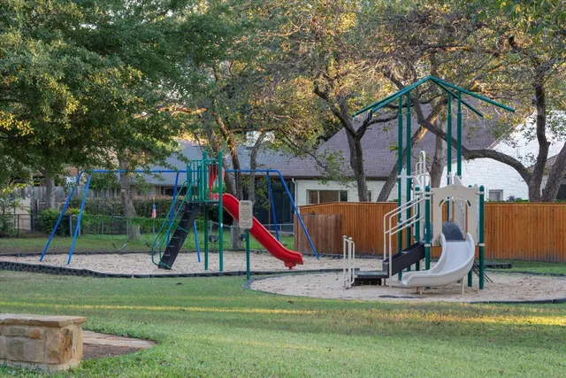 a view of a park with swings and slides