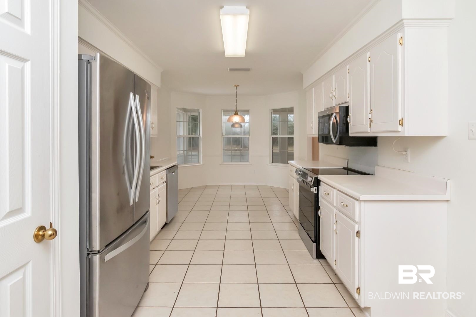 10006 Wedgefield Court Mobile, AL 36608 - Photo 23 of 34 Kitchen with stainless steel appliances, light countertops, white cabinetry, and decorative light fixtures