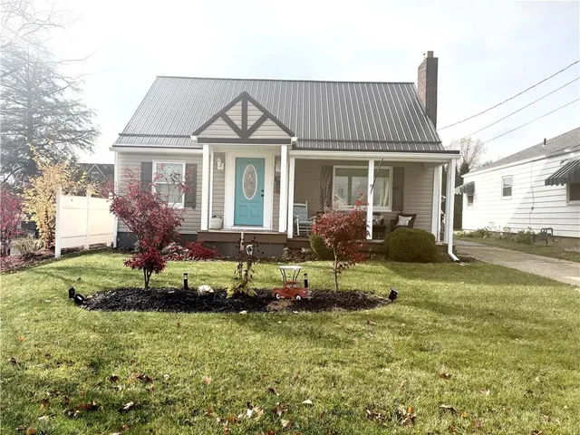 a view of a house with a yard and garage