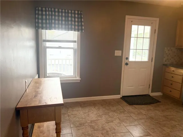 a view of a room with wooden floor and staircase