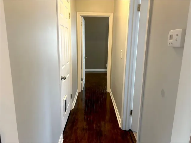 a view of a room with wooden floor and fan