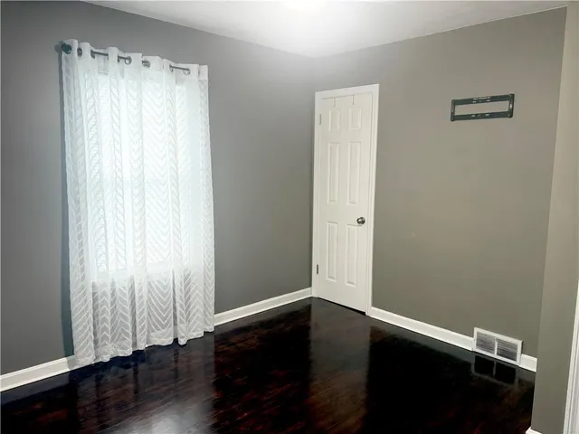 a view of a small space with wooden floor