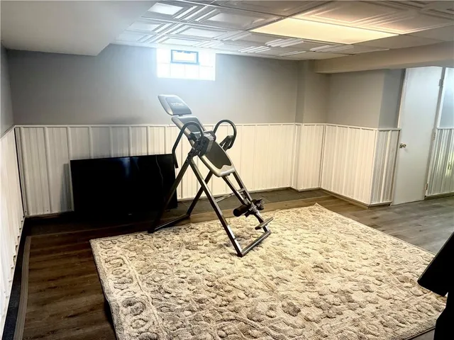 a bathroom with a sink shower and a mirror