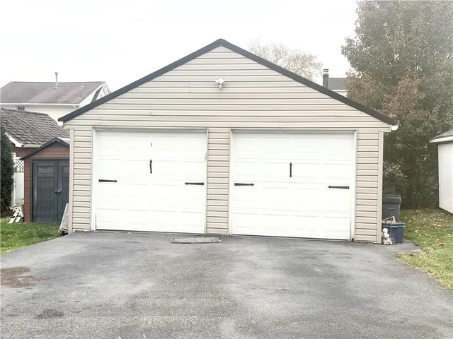 a metallic refrigerator freezer sitting in a kitchen