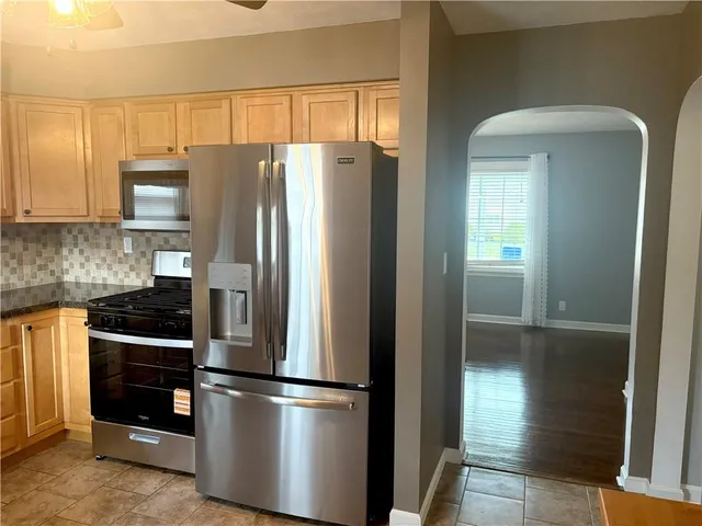 a view of an entryway with wooden floor