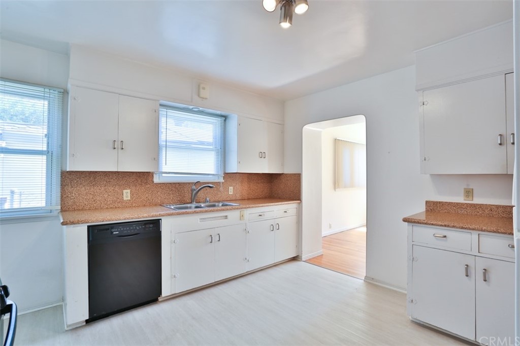 2235 Garfias Drive Pasadena, CA 91104 - Photo 11 of 40 a kitchen with granite countertop white cabinets and white appliances