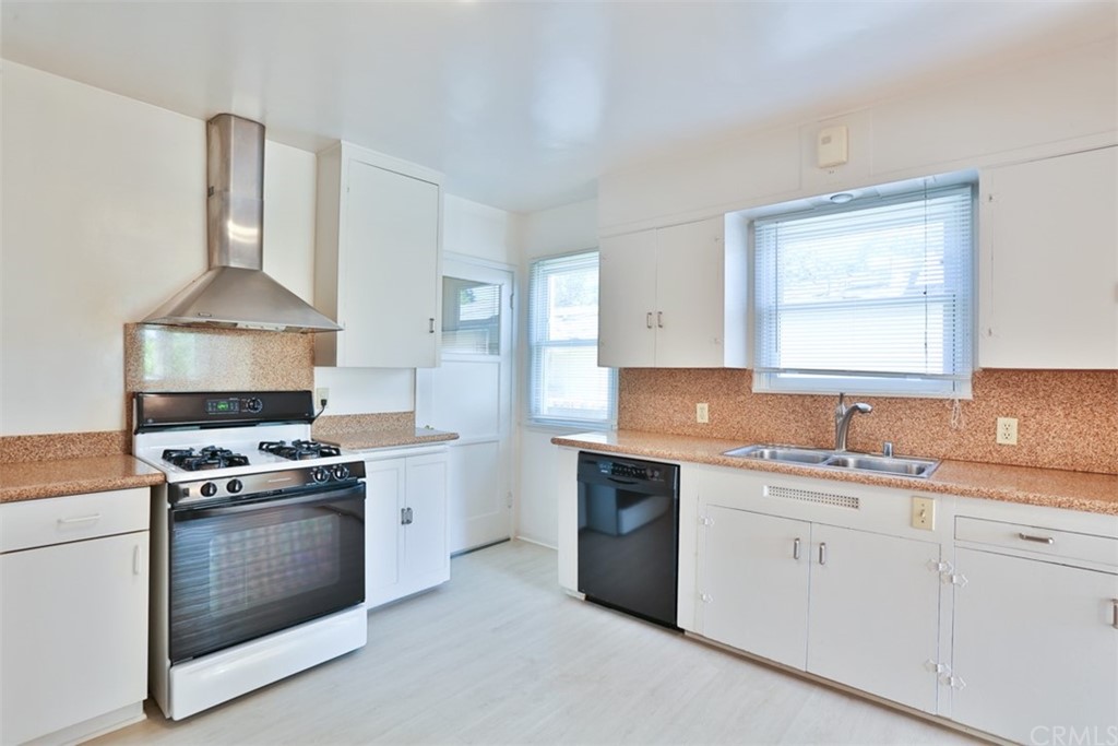 2235 Garfias Drive Pasadena, CA 91104 - Photo 12 of 40 a kitchen with a stove sink and cabinets