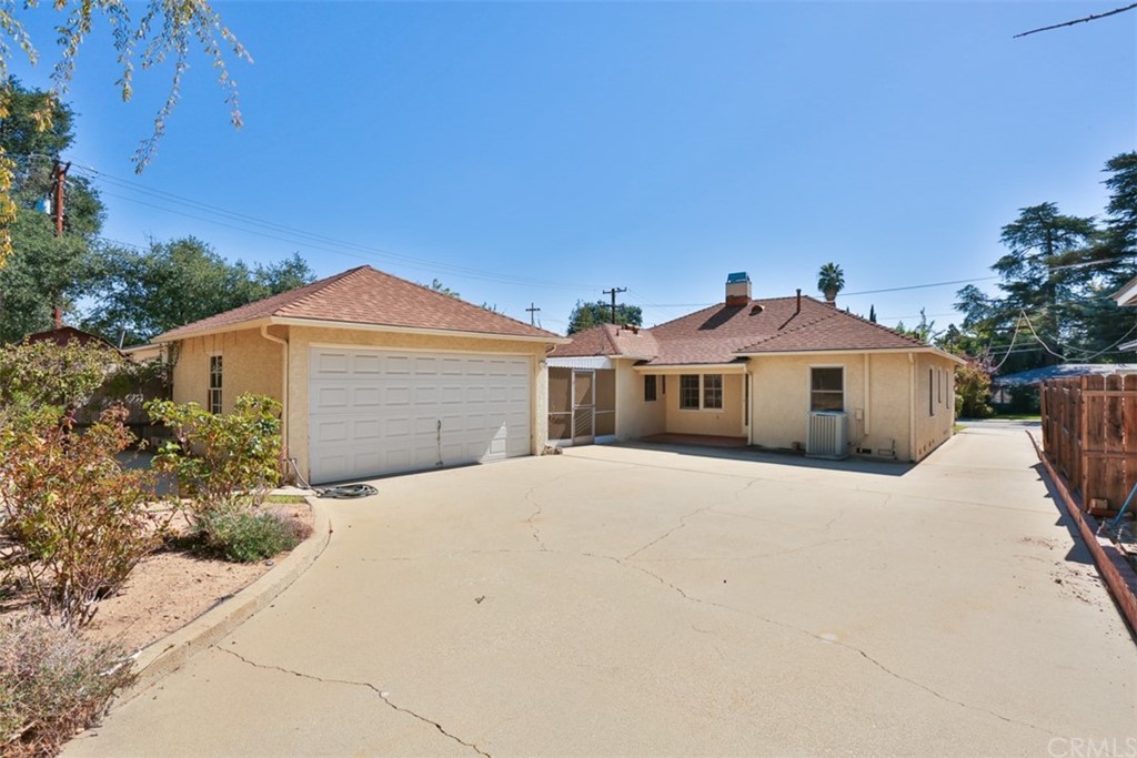 2235 Garfias Drive Pasadena, CA 91104 - Photo 26 of 40 a front view of a house with a yard and garage