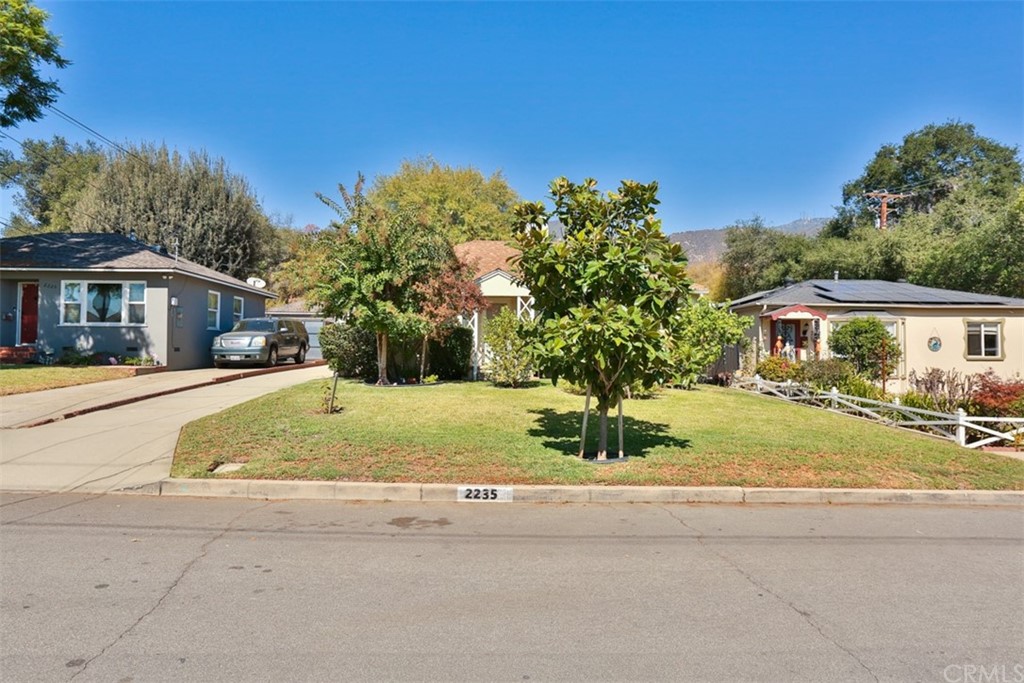 2235 Garfias Drive Pasadena, CA 91104 - Photo 31 of 40 a yellow house with trees in front of it
