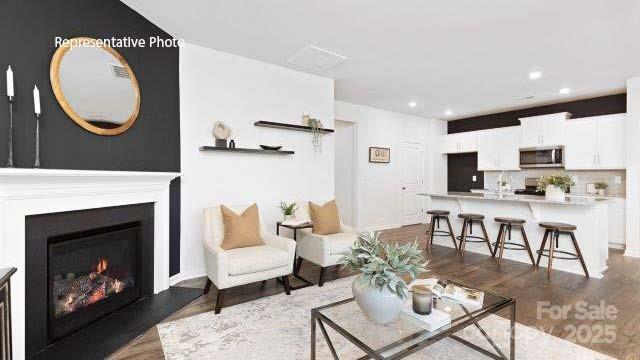 1039 Horizon Lane Chester, SC 29706 - Photo 9 of 21 a living room with furniture a fireplace and kitchen view