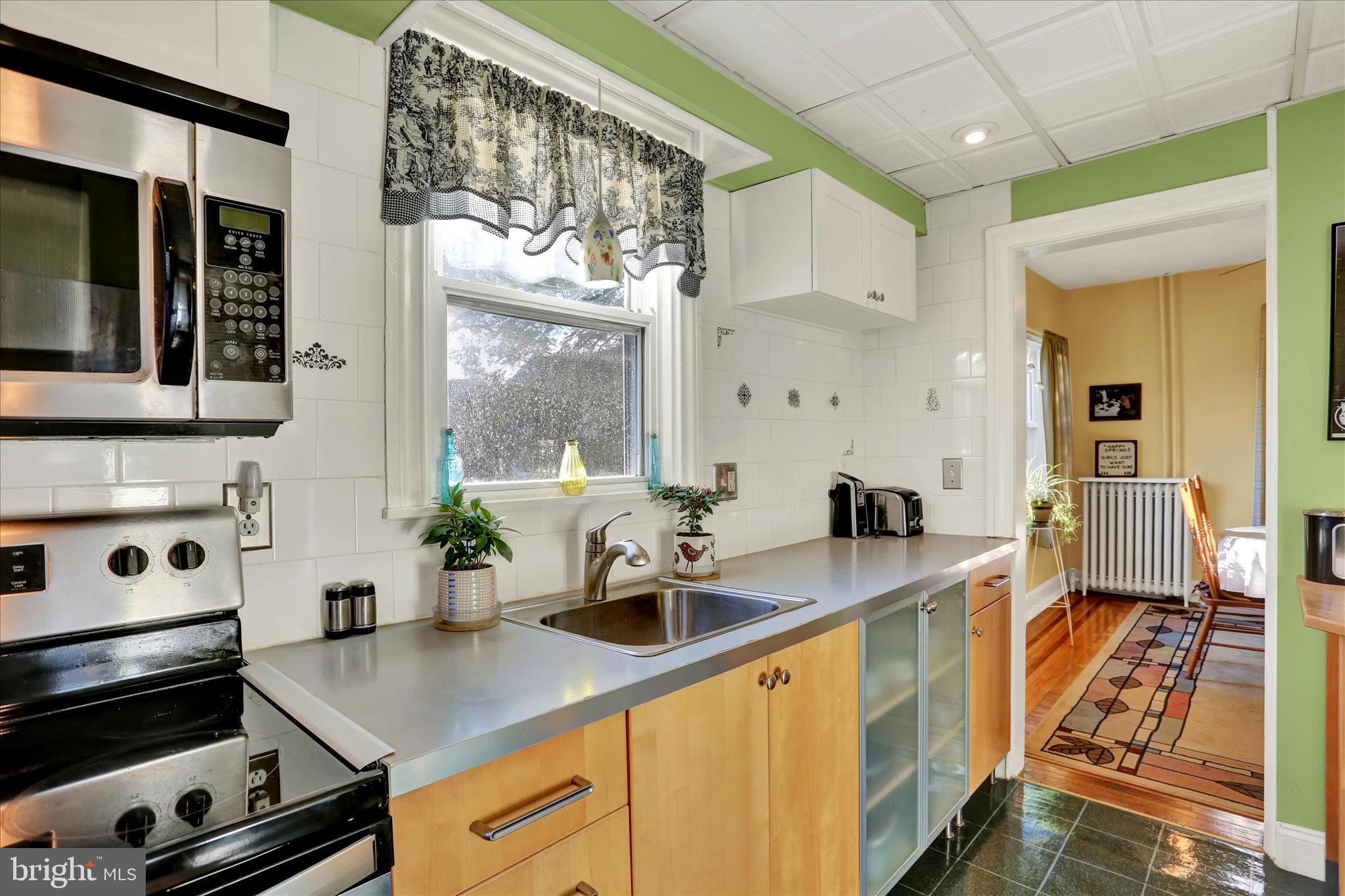 117 Center Street Reading, PA 19606 - Photo 6 of 28 a kitchen with stainless steel appliances a sink a stove and a wooden floors