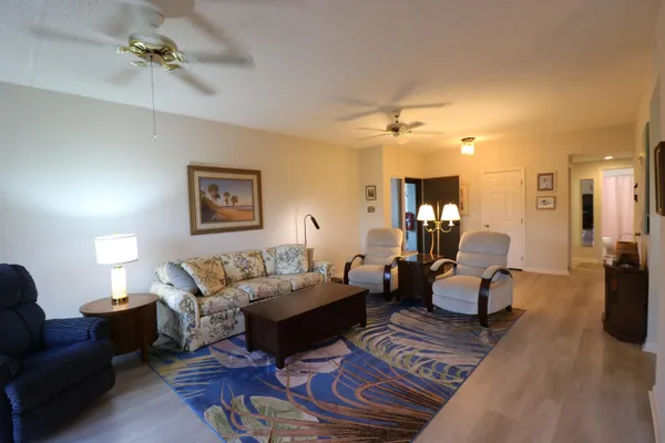 a room with table chairs and a chandelier