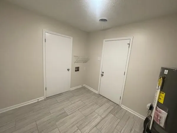 an empty room with wooden floor and a ceiling fan