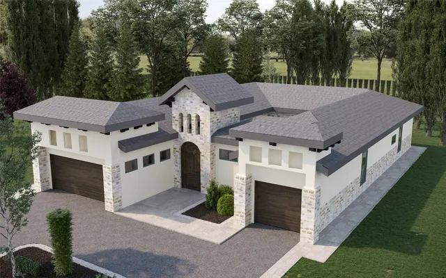a aerial view of a house with a yard potted plants and a table under an umbrella