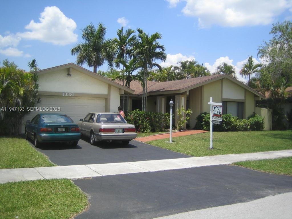 a couple of cars parked in front of a house