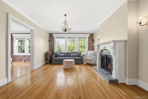 a living room with furniture fireplace and wooden floor