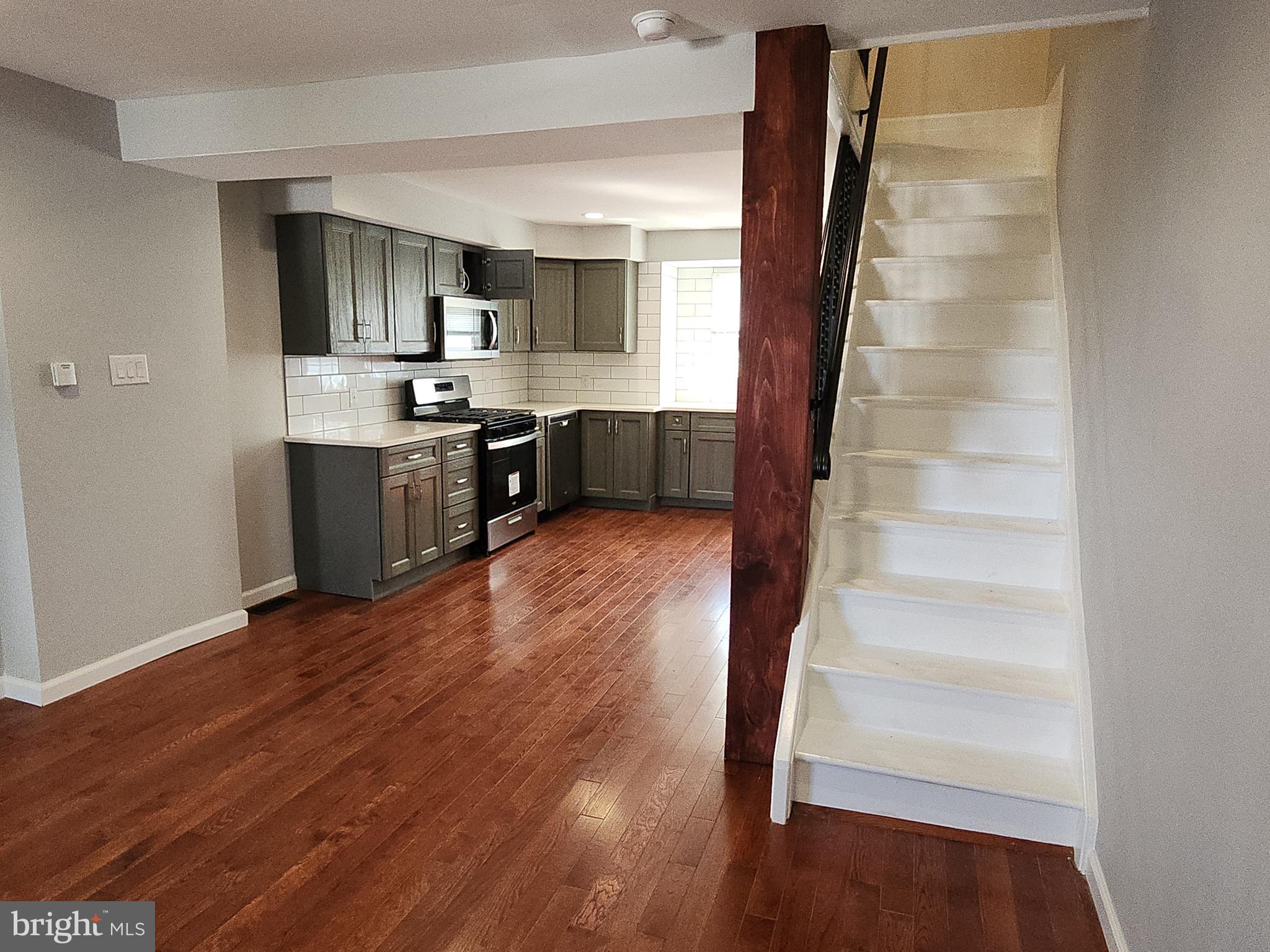 2686 Bridge Street Philadelphia, PA 19137 - Photo 5 of 30 a view of a kitchen with wooden floors and a sink