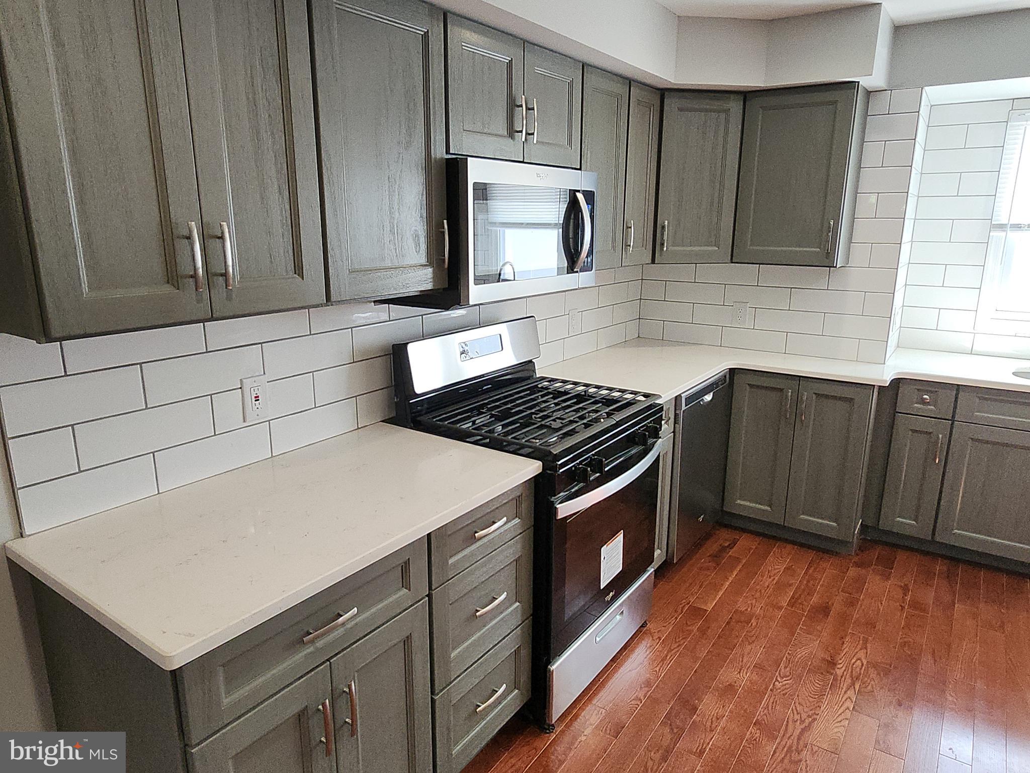 2686 Bridge Street Philadelphia, PA 19137 - Photo 7 of 30 a kitchen with wooden cabinets and a stove top oven
