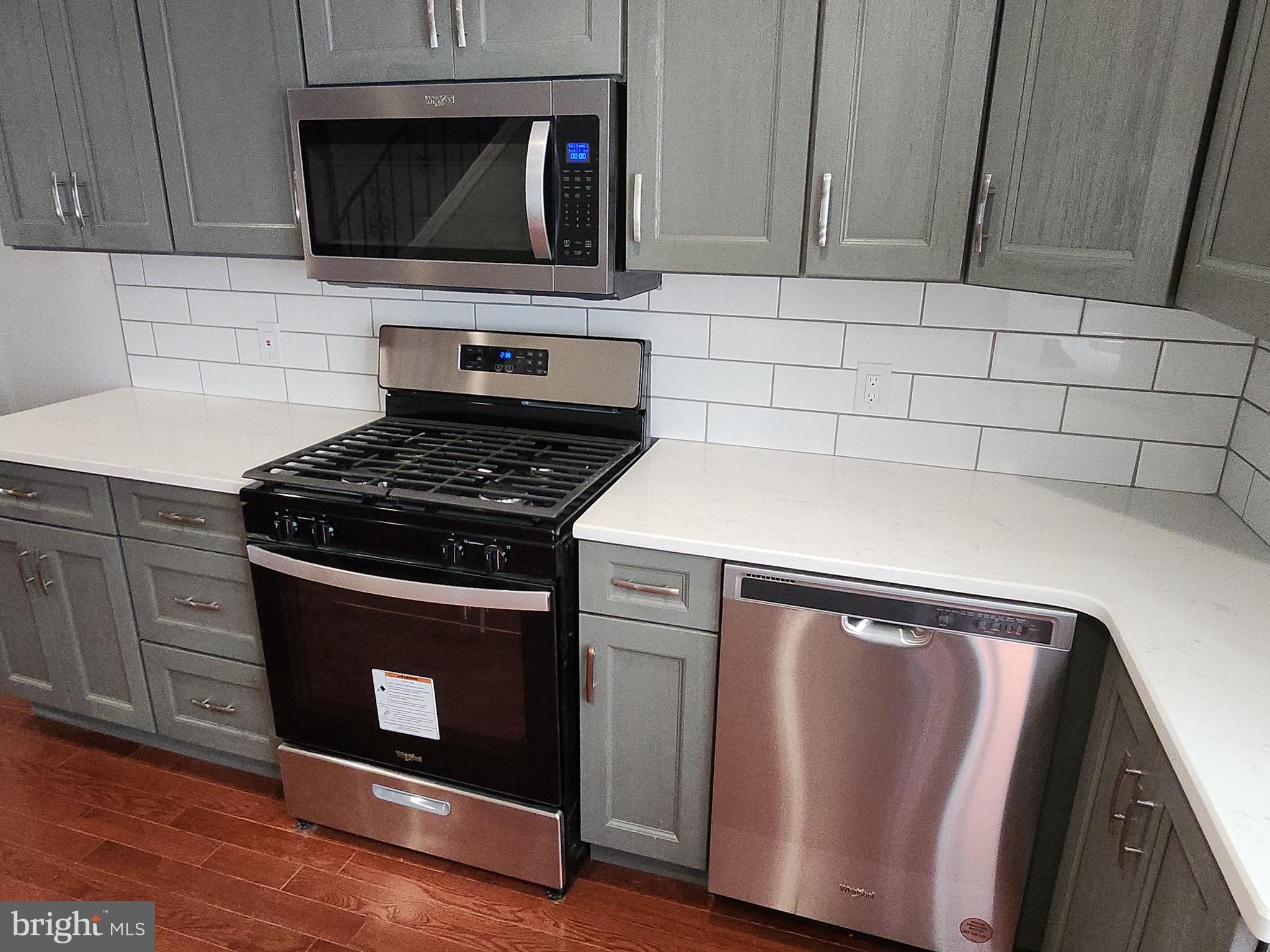 2686 Bridge Street Philadelphia, PA 19137 - Photo 8 of 30 a kitchen with granite countertop cabinets stainless steel appliances and wooden floor