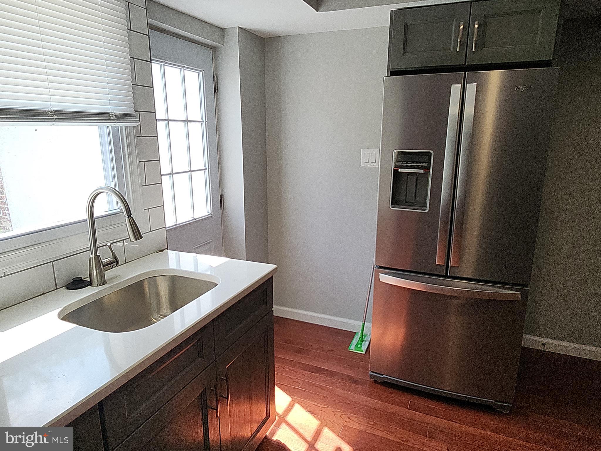 2686 Bridge Street Philadelphia, PA 19137 - Photo 9 of 30 a kitchen with sink a refrigerator and wooden floor