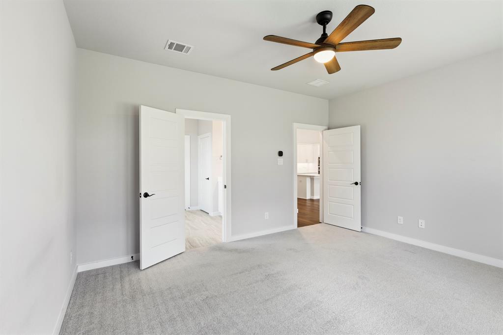 3311 Willena Road Melissa, TX 75454 - Photo 29 of 40 Spacious room featuring light gray carpeting and two paneled interior doors with matte black hardware