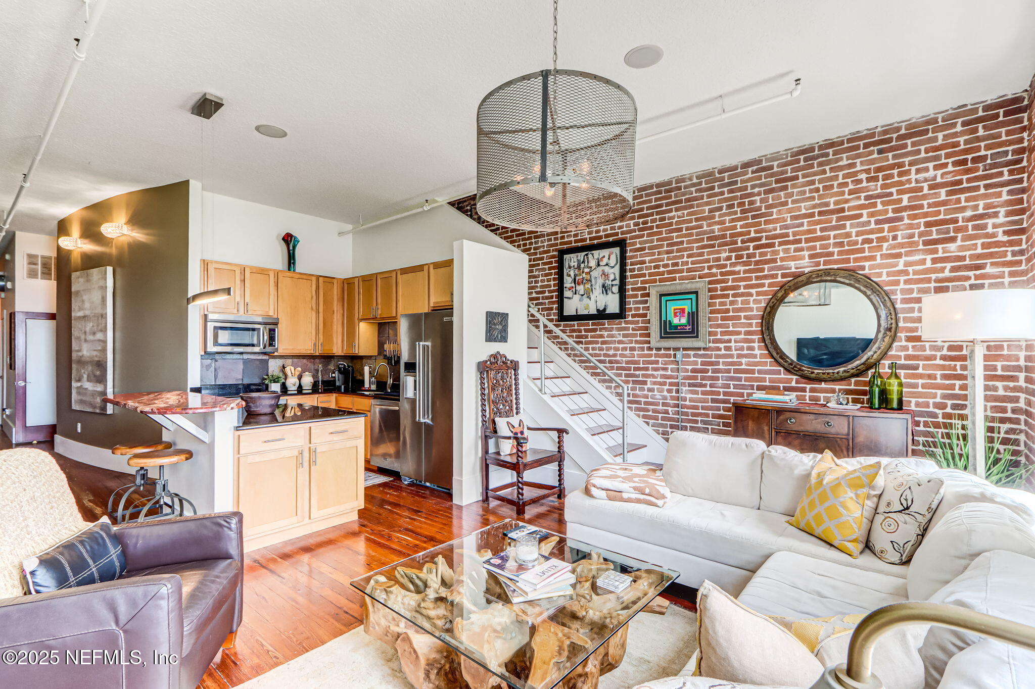 301 East Bay Street, Unit 405 Jacksonville, FL 32202 - Photo 1 of 42 a living room with furniture kitchen view and a wooden floor
