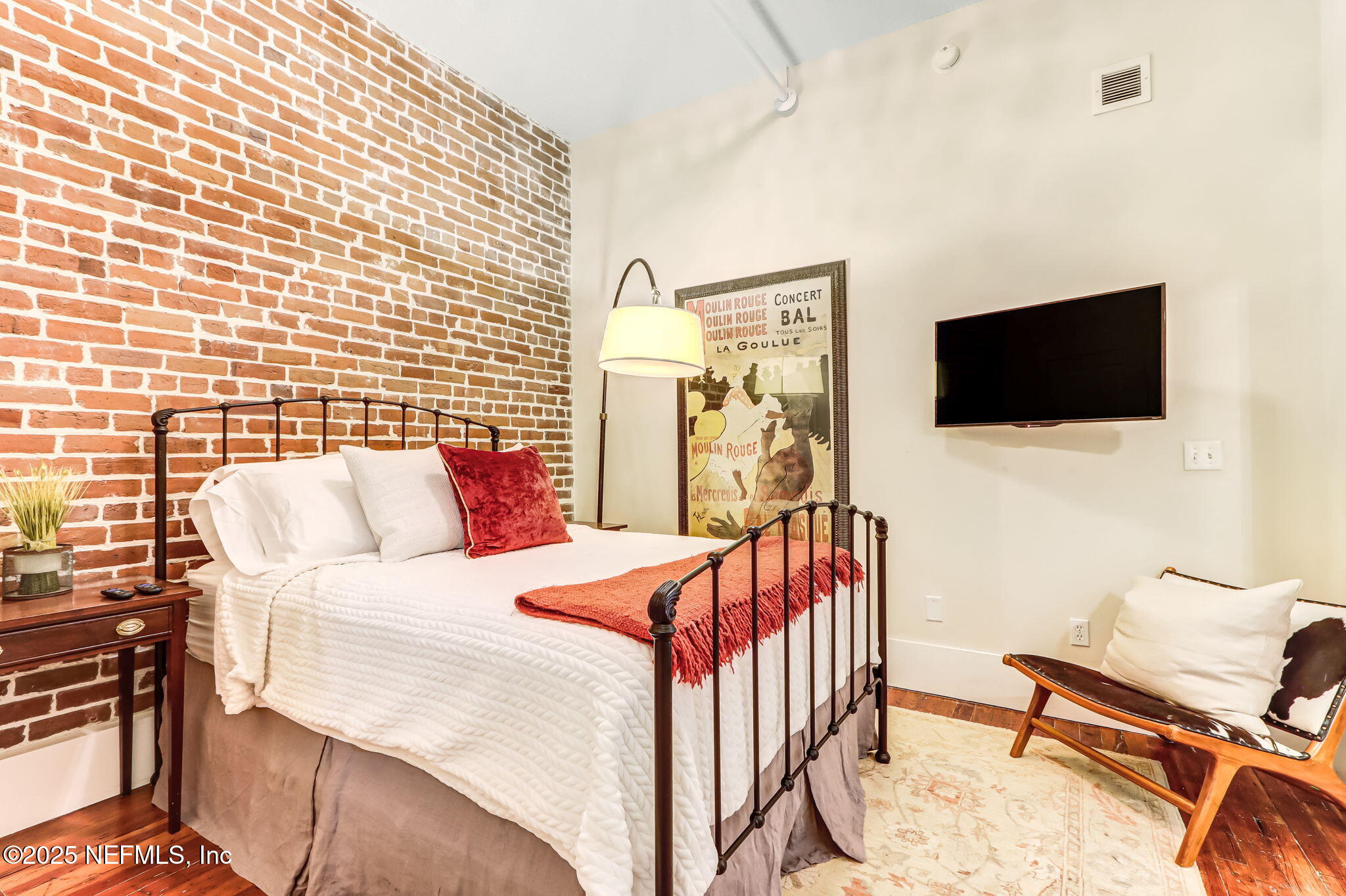 301 East Bay Street, Unit 405 Jacksonville, FL 32202 - Photo 16 of 42 a bedroom with a bed and a flat screen tv