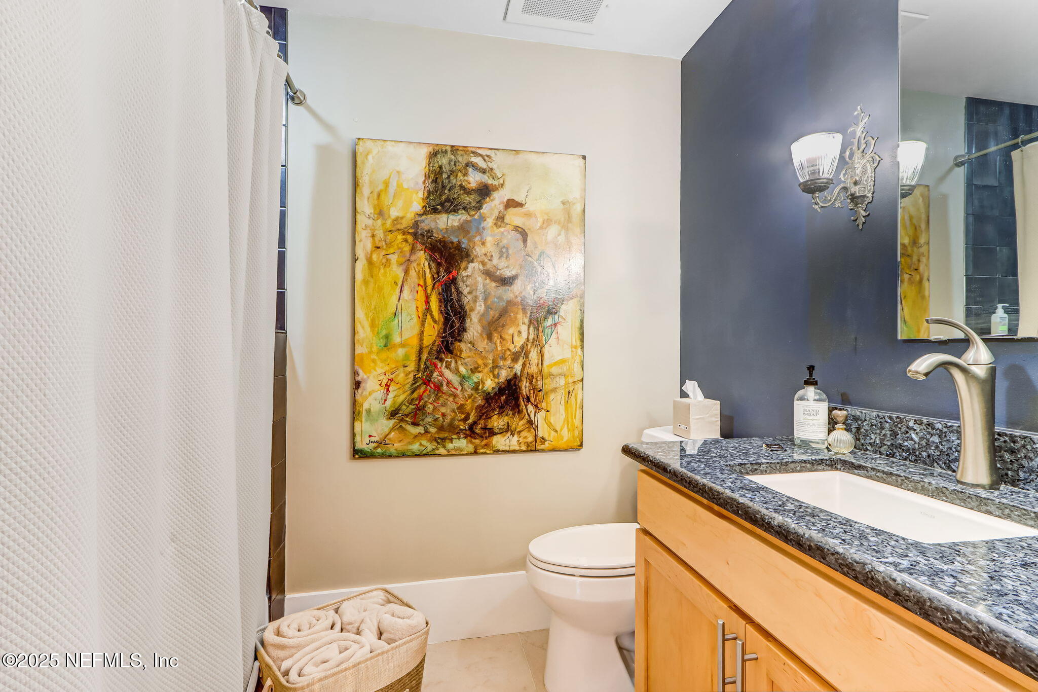 301 East Bay Street, Unit 405 Jacksonville, FL 32202 - Photo 17 of 42 a bathroom with a granite countertop sink mirror vanity and toilet