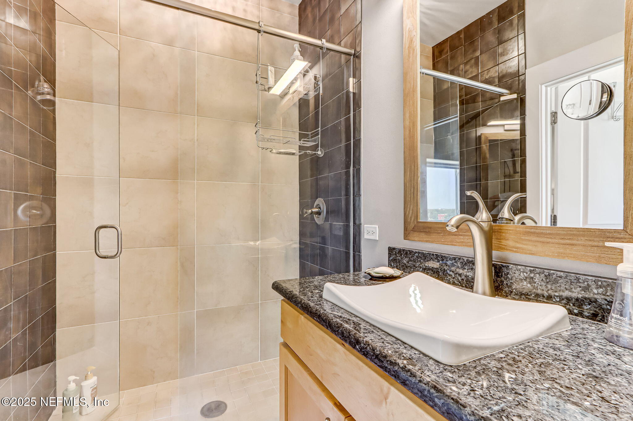 301 East Bay Street, Unit 405 Jacksonville, FL 32202 - Photo 30 of 42 a bathroom with a granite countertop sink and a mirror