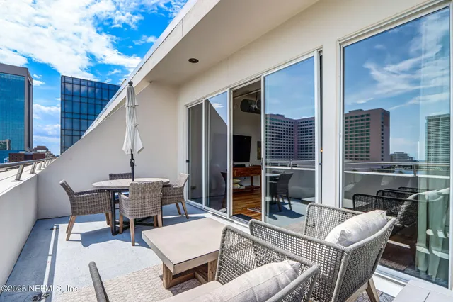 a view of a kitchen with a dining table and chairs