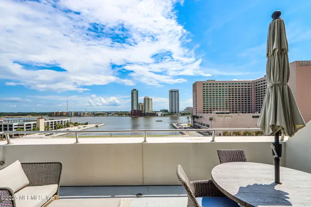 a view of a patio with table and chairs and potted plants