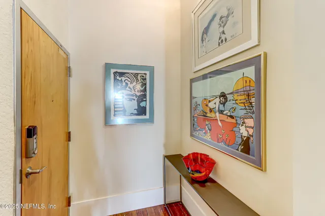 a view of a hallway with wooden floor