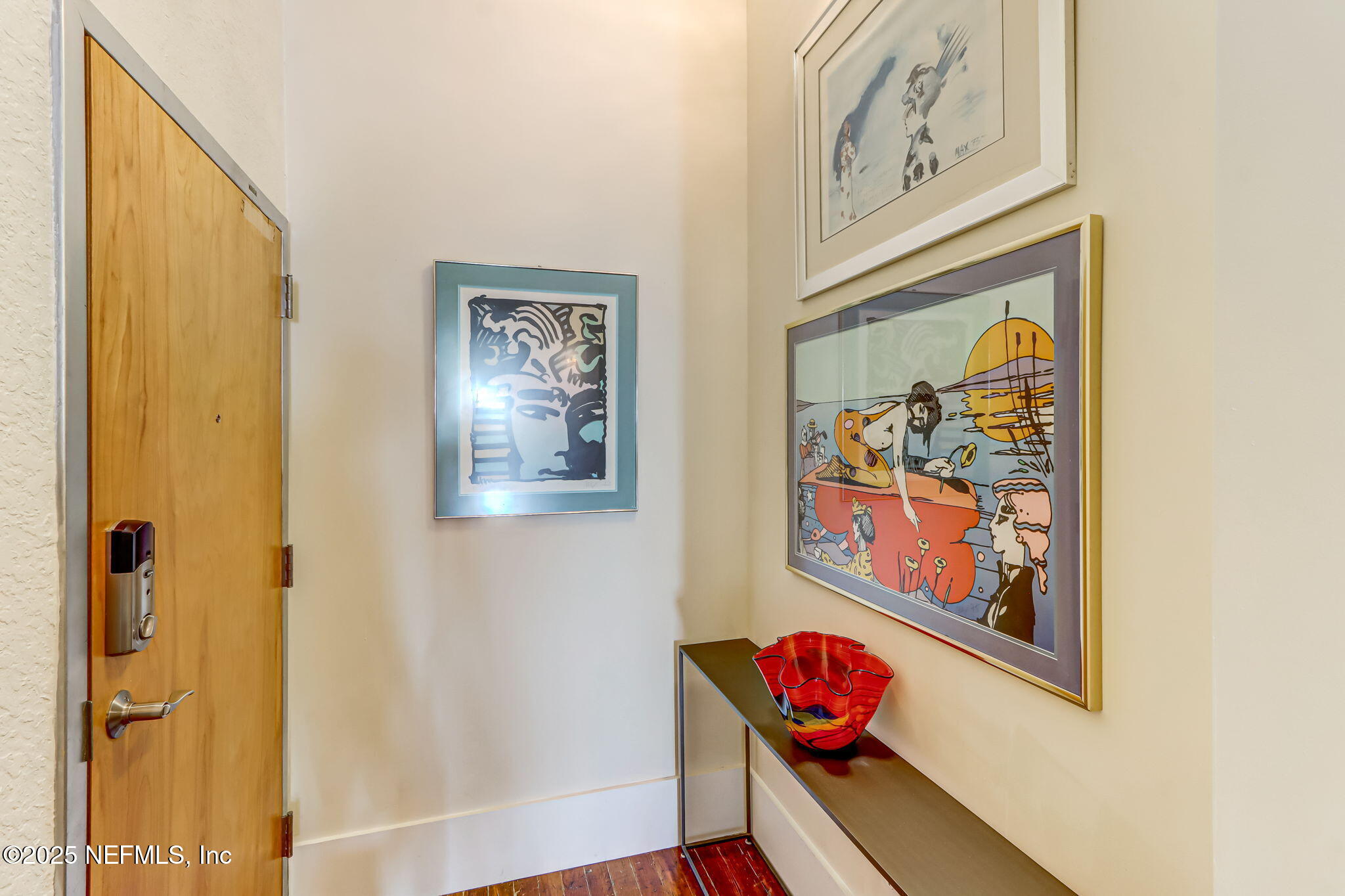 301 East Bay Street, Unit 405 Jacksonville, FL 32202 - Photo 7 of 42 a picture of a hallway with wooden floor and a bathroom