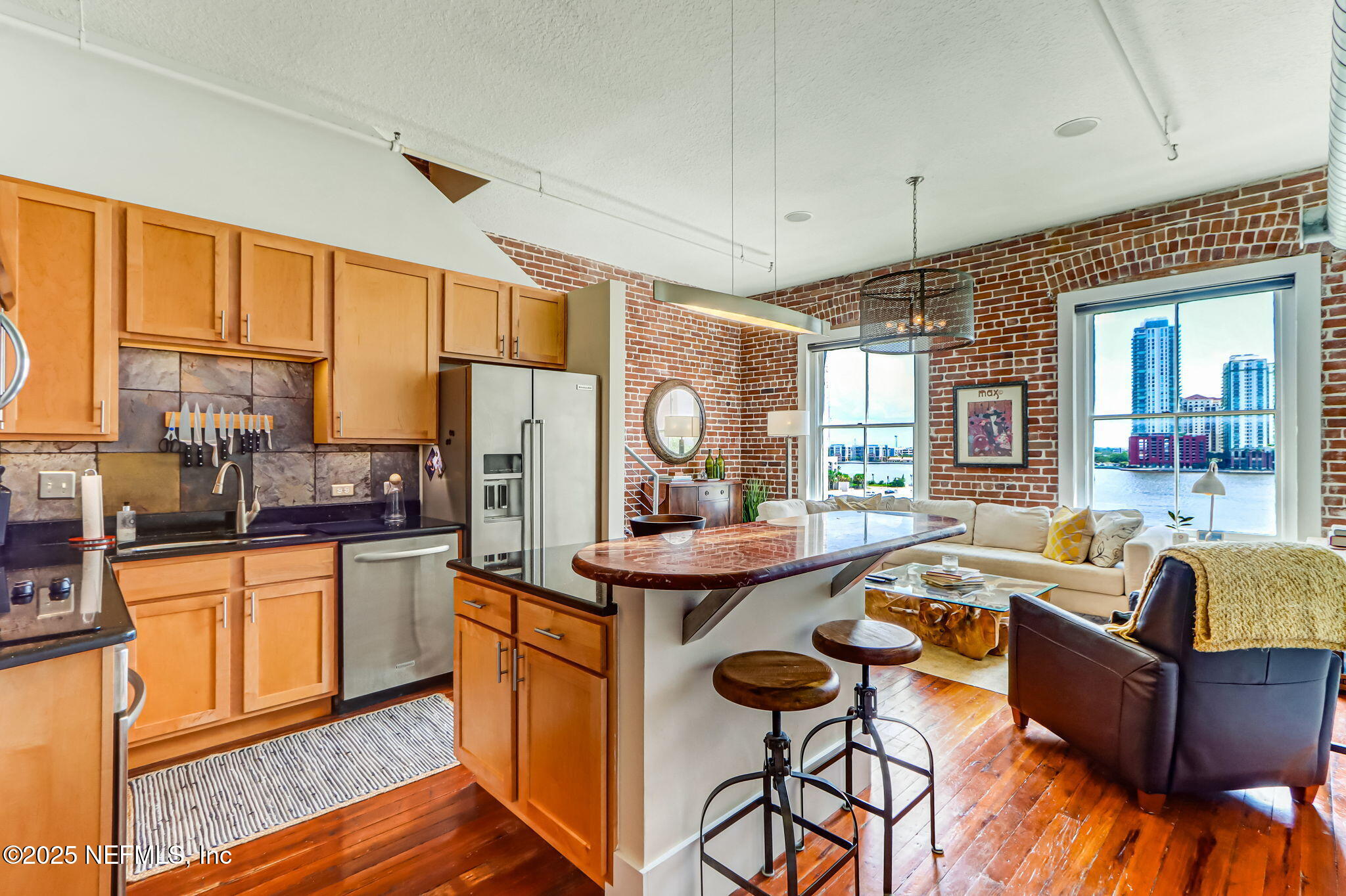 301 East Bay Street, Unit 405 Jacksonville, FL 32202 - Photo 9 of 42 a kitchen with stainless steel appliances granite countertop a sink and a refrigerator
