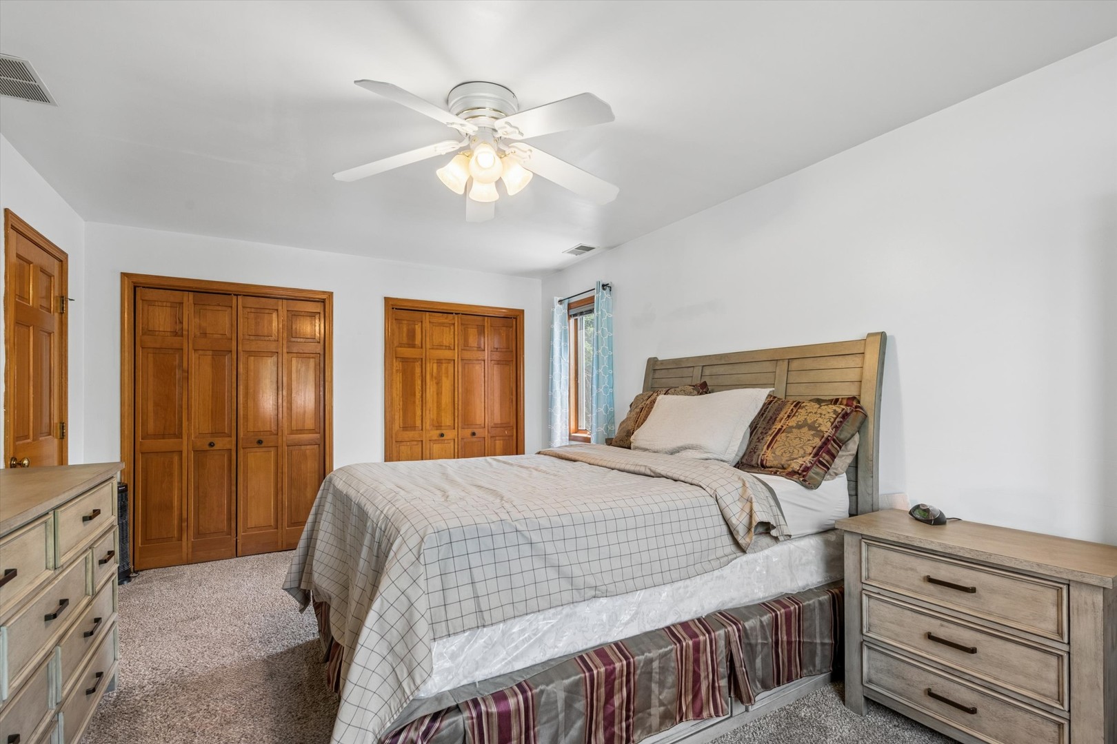 2142 North Summit Street Wheaton, IL 60187 - Photo 22 of 35 a bedroom with a bed and a chandelier