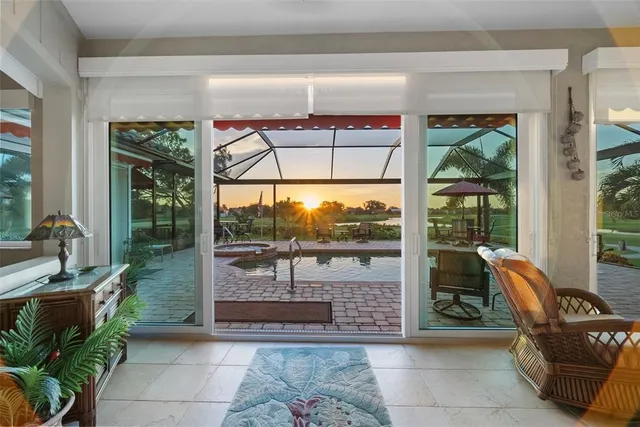 a view of a patio with table and chairs potted plants and a large tree