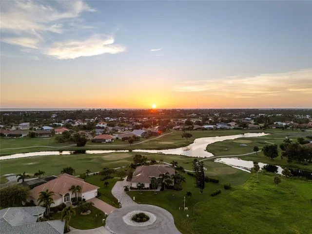 a view of a house with a yard and potted plants