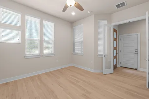 wooden floor in an empty room with a window