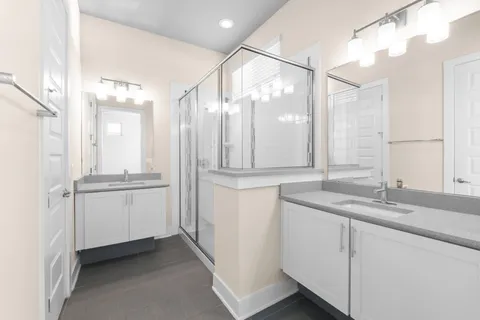 a bathroom with a granite countertop sink mirror and double