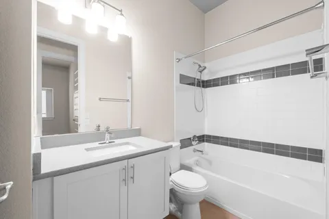 a bathroom with a sink mirror toilet and bathtub