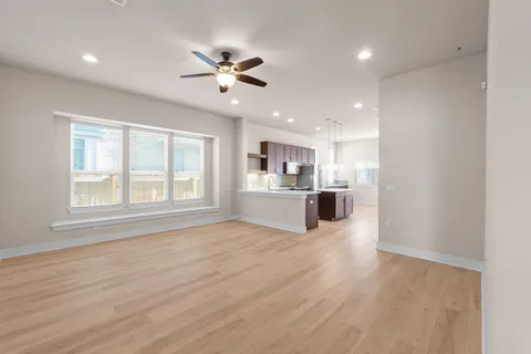 a view of a kitchen with a sink dishwasher cabinets and wooden floor