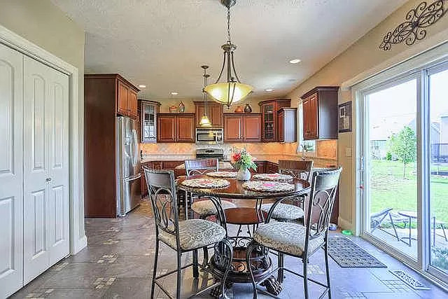 5102 Jacks Boulevard Champaign, IL 61822 - Photo 11 of 36 a view of a dining room with furniture window and wooden floor