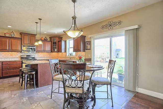 5102 Jacks Boulevard Champaign, IL 61822 - Photo 12 of 36 a view of a dining room with furniture window and wooden floor