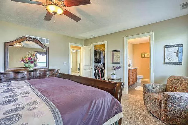 5102 Jacks Boulevard Champaign, IL 61822 - Photo 15 of 36 a bedroom with a large bed a chandelier and dresser