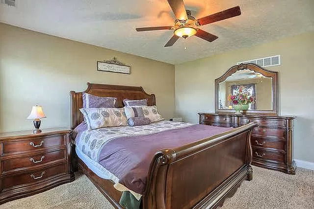 5102 Jacks Boulevard Champaign, IL 61822 - Photo 17 of 36 a bedroom with a bed and a chandelier