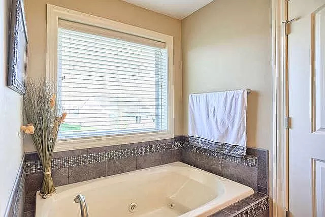 5102 Jacks Boulevard Champaign, IL 61822 - Photo 18 of 36 a bathroom with a tub and a window