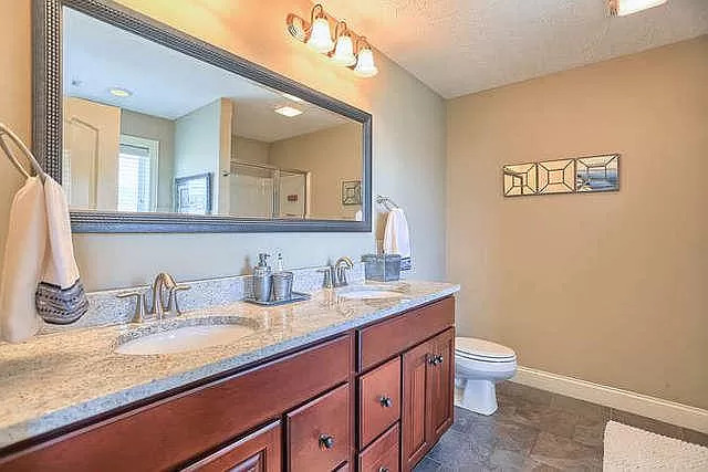5102 Jacks Boulevard Champaign, IL 61822 - Photo 21 of 36 a bathroom with a granite countertop sink a large mirror and toilet