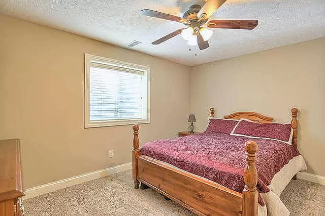 5102 Jacks Boulevard Champaign, IL 61822 - Photo 22 of 36 a bedroom with a bed and a chandelier